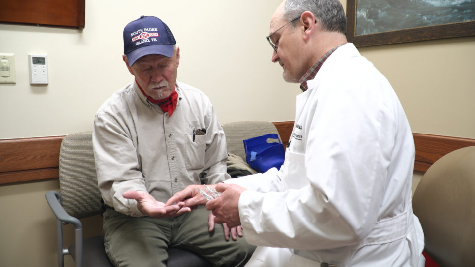 Dr Grillot examining a hand